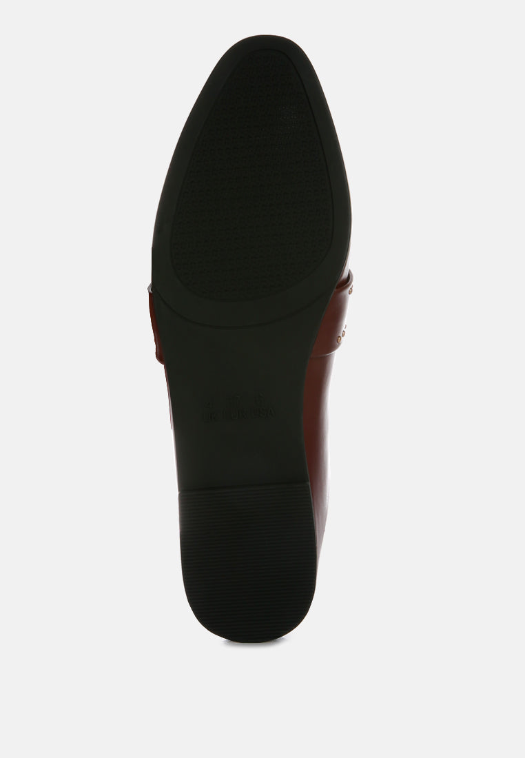Black mules with studded strap detail and textured rubber outsole