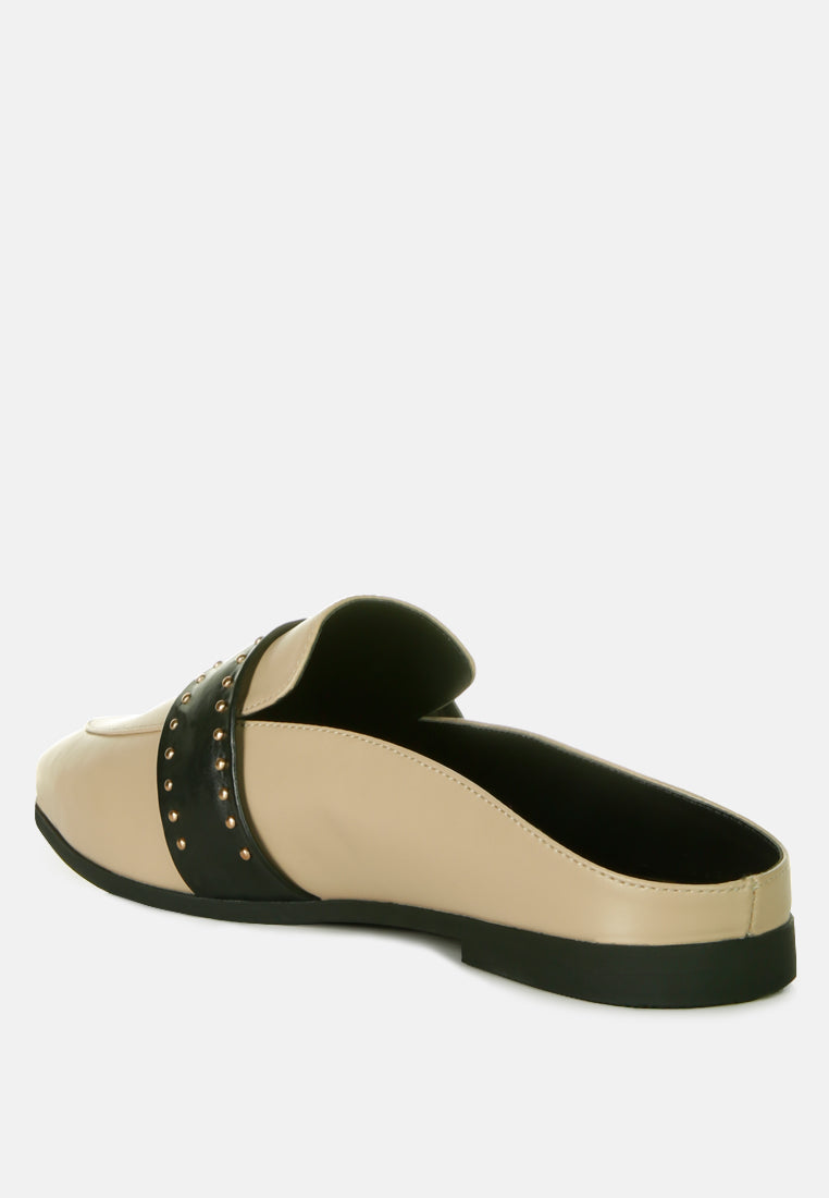 Side view of taupe mules with black studded band and cushioned faux leather upper