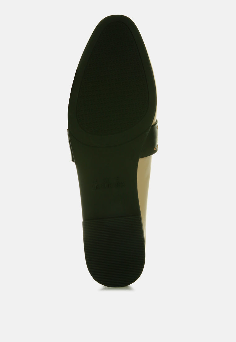 Bottom view of taupe faux leather mules with studded strap and flat rubber sole
