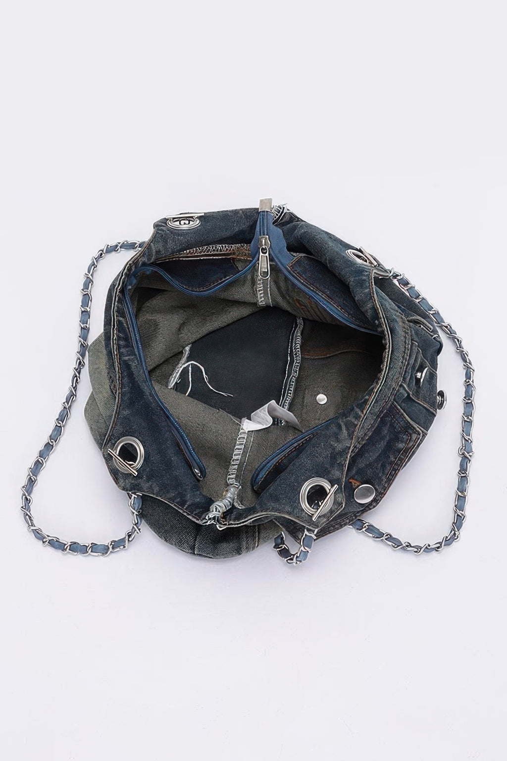 Washed denim tote bag open top view with chain strap and interior lining visible