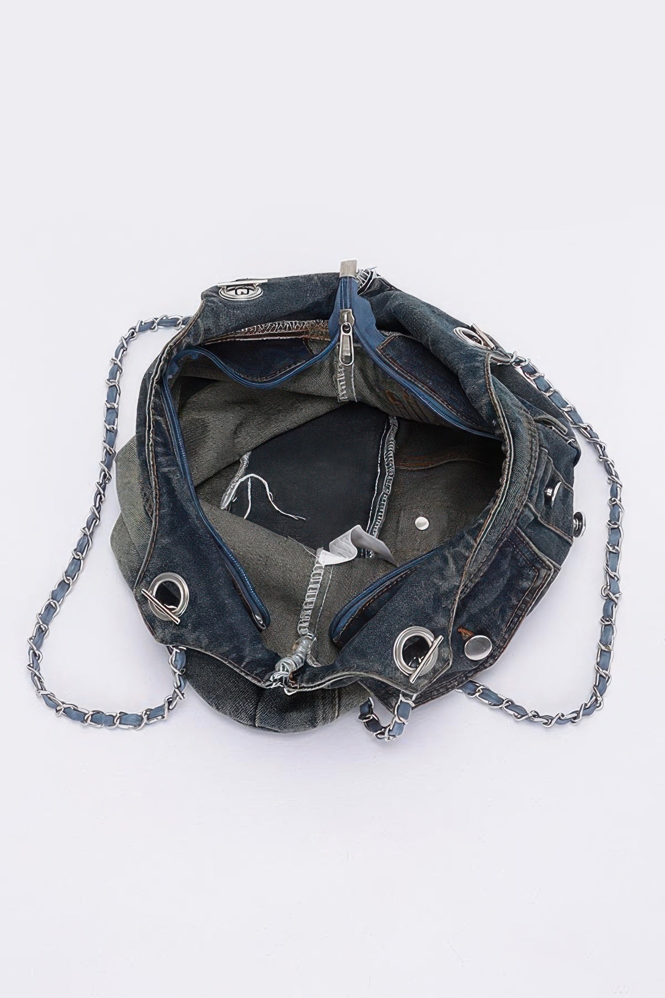 Washed denim tote bag open top view with chain strap and interior lining visible