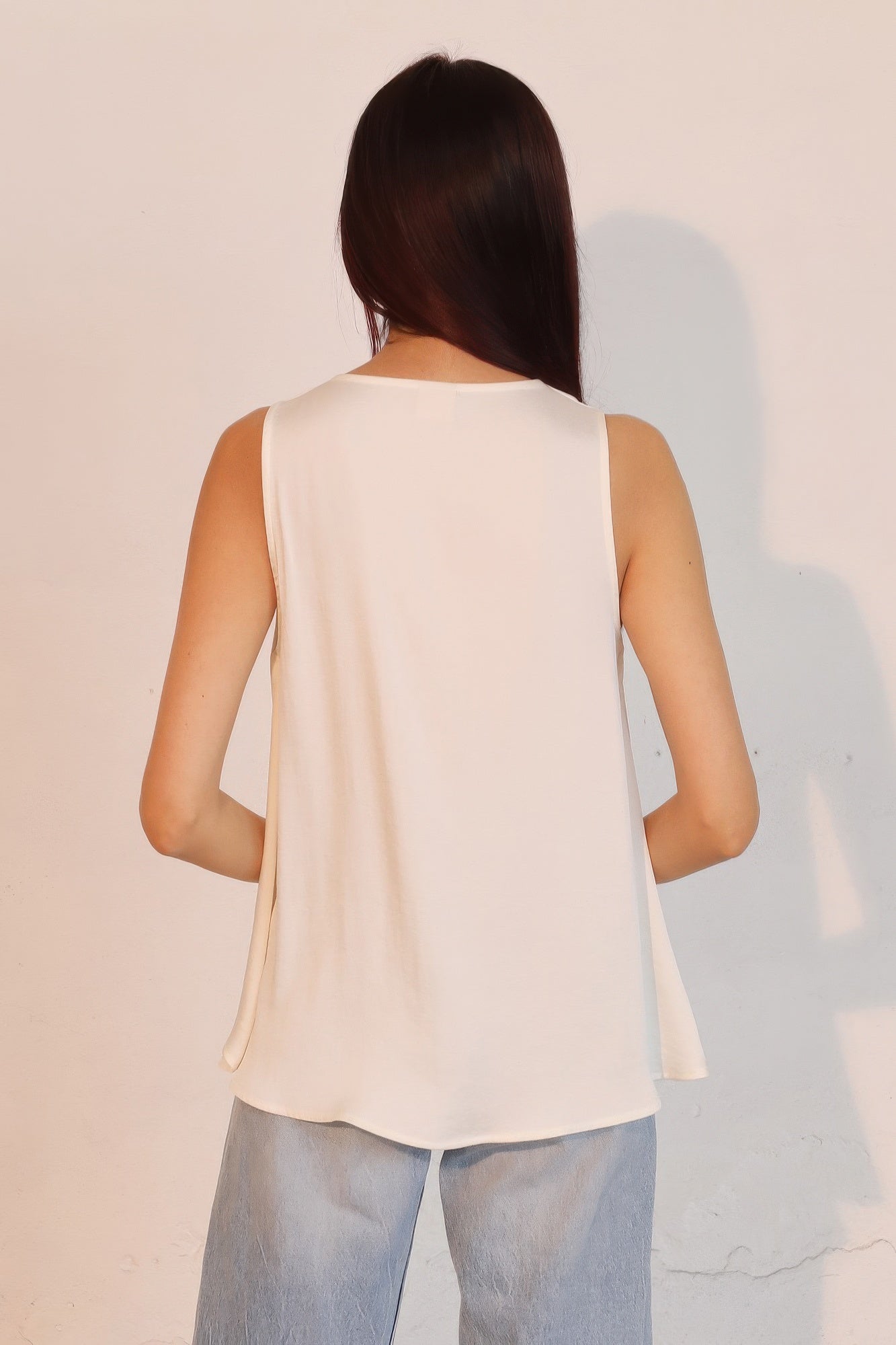 Washed poly silk front tucked top, ivory back view with flowing draped hem