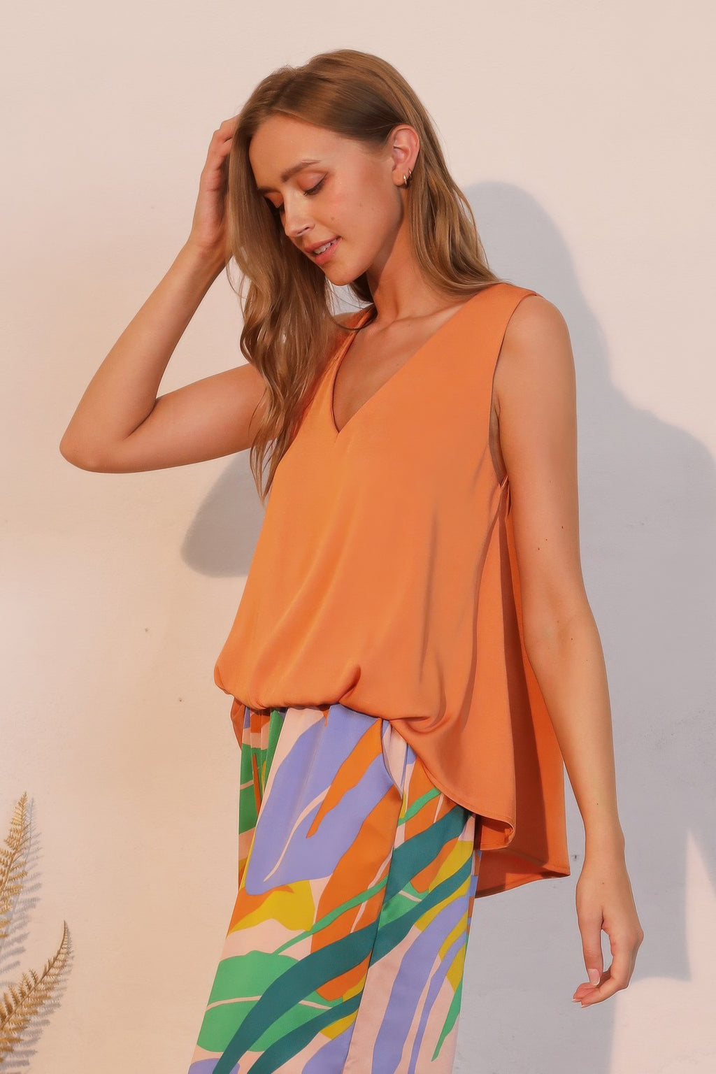 Washed poly silk front tucked top, pumpkin sleeveless V-neck with soft drape