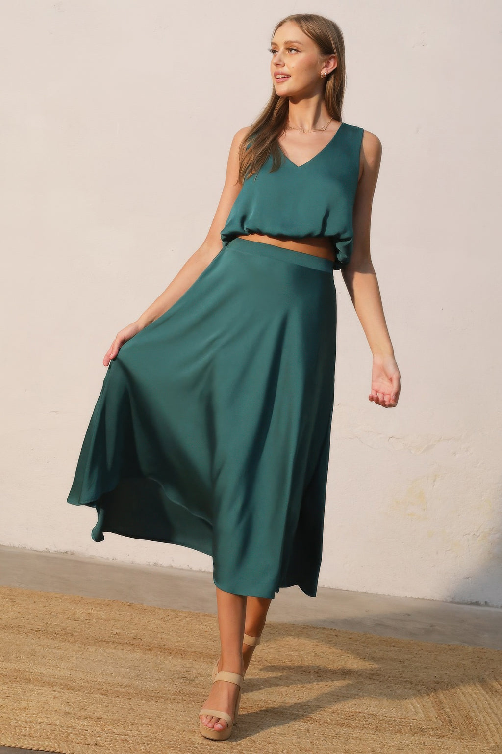 Teal-green midi swing skirt with elastic waistband and layered, flared hem