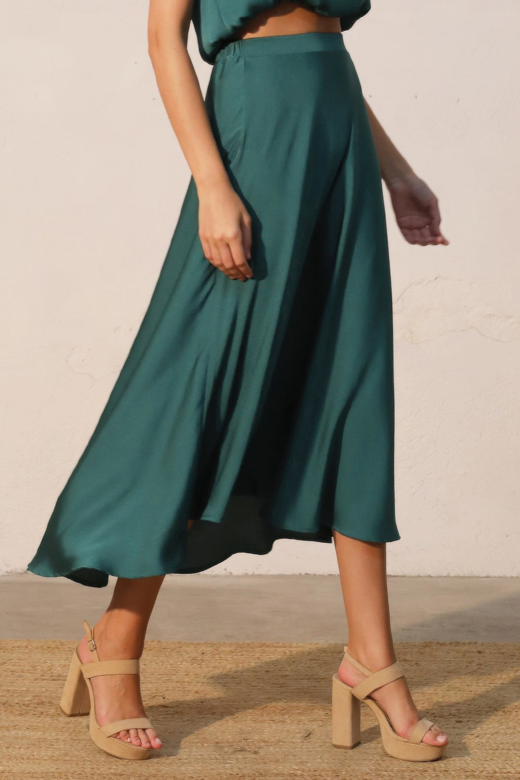 Deep green midi swing skirt showing gathered waist and wide, swishy silhouette