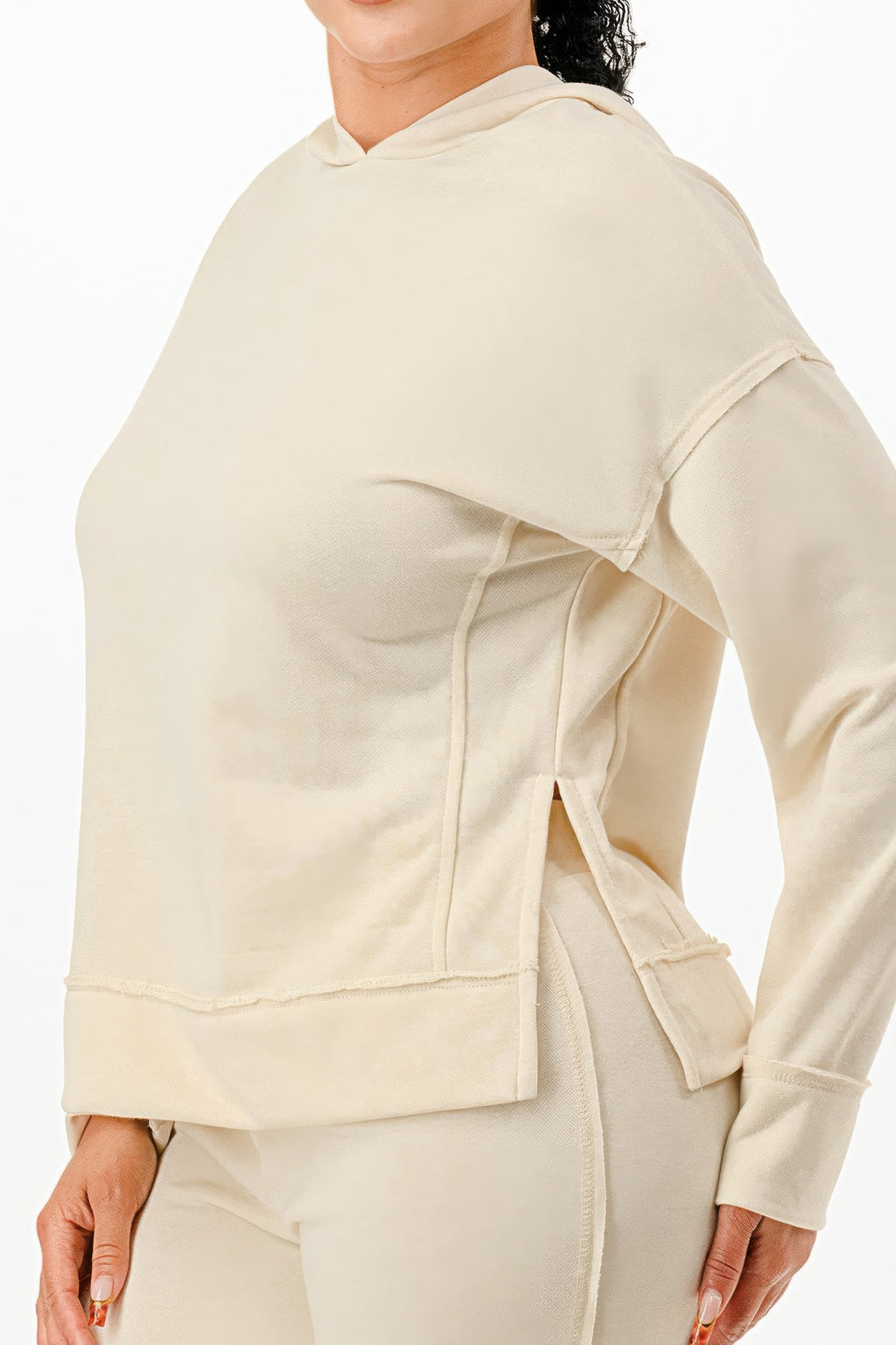 Cream hoodie detail with hood drawstring and front pocket seam