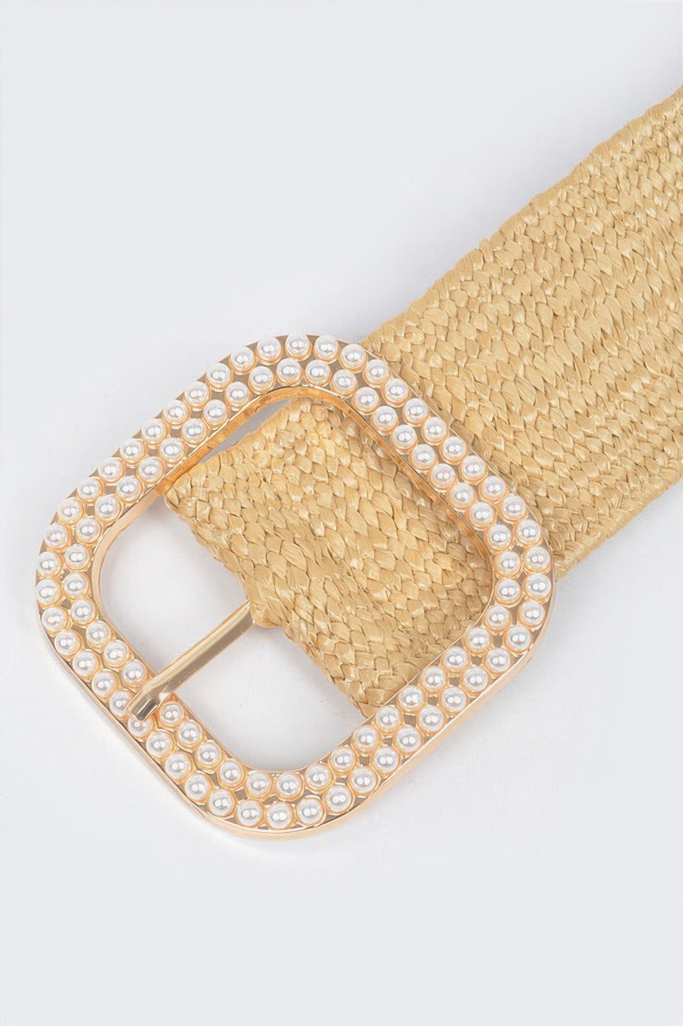 Close-up of nude gold weaved belt buckle with square pearl and rhinestone trim