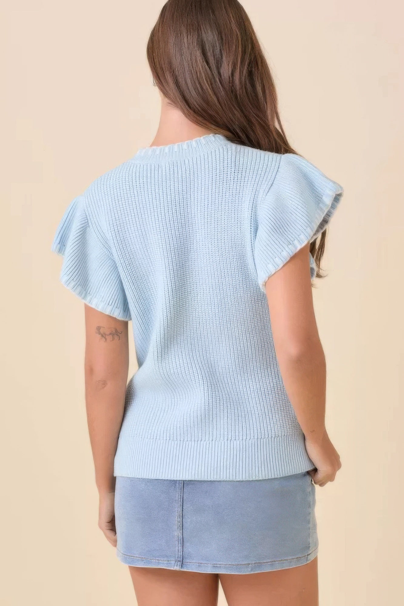 Light blue knit sweater top with short sleeves, back view
