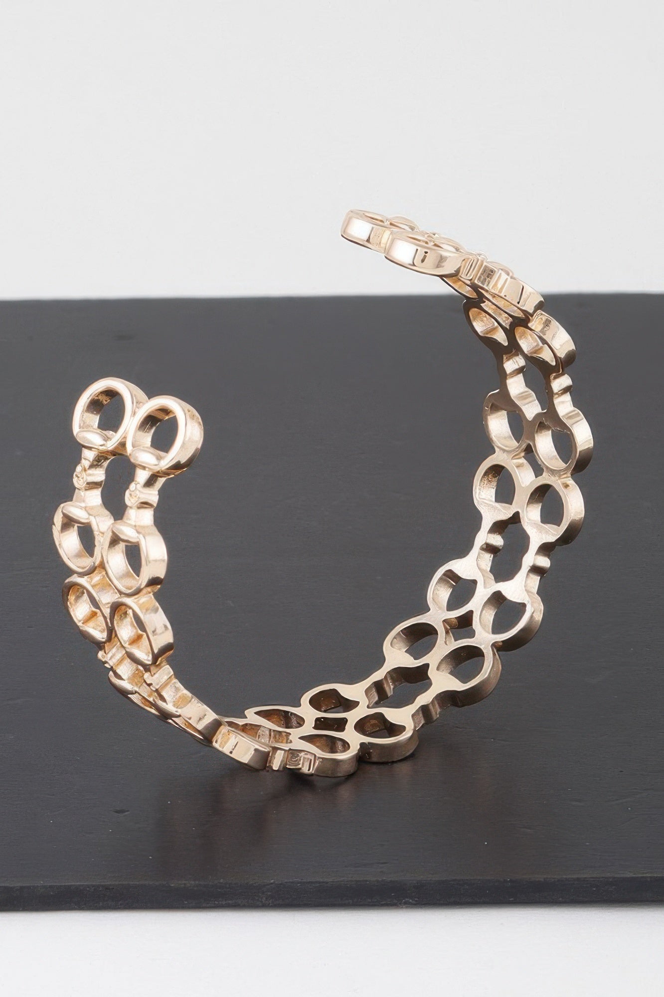 Gold welded ring chain cuff bracelet side view with segmented ring links