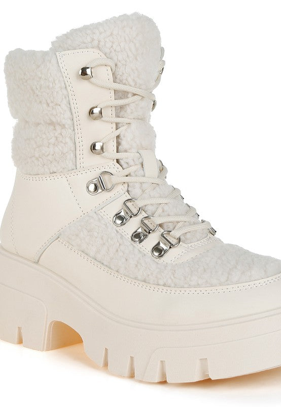 Beige faux-fur hiker boots with lace-up front and chunky tread sole