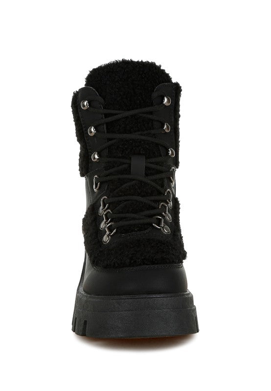 Black faux-fur lace-up hiker boot with metal hardware and thick sole