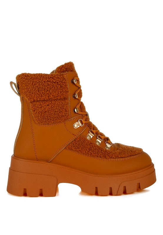Tan faux-fur hiker boot with lace-up front and chunky tread sole