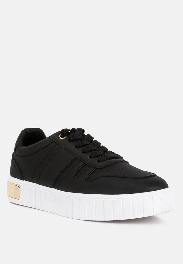 Black lace-up low-top sneakers with stitched side panels and gold eyelet tabs