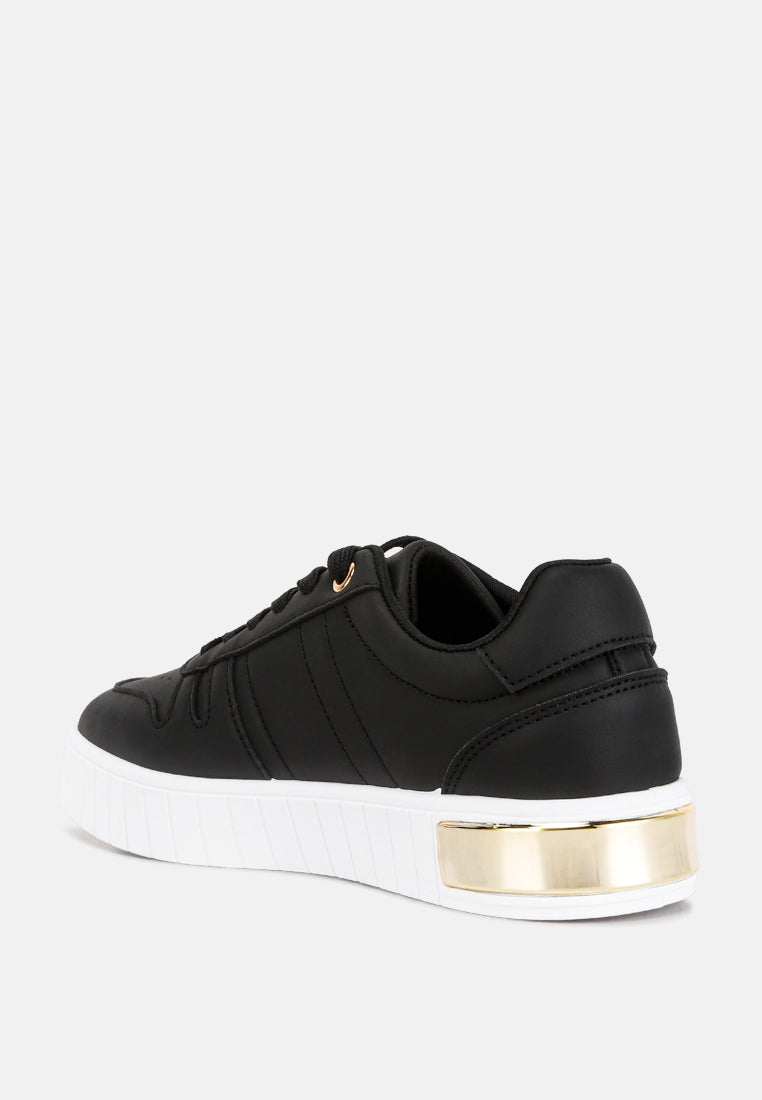 Black sneakers rear view with gold heel trim and contrast white sole