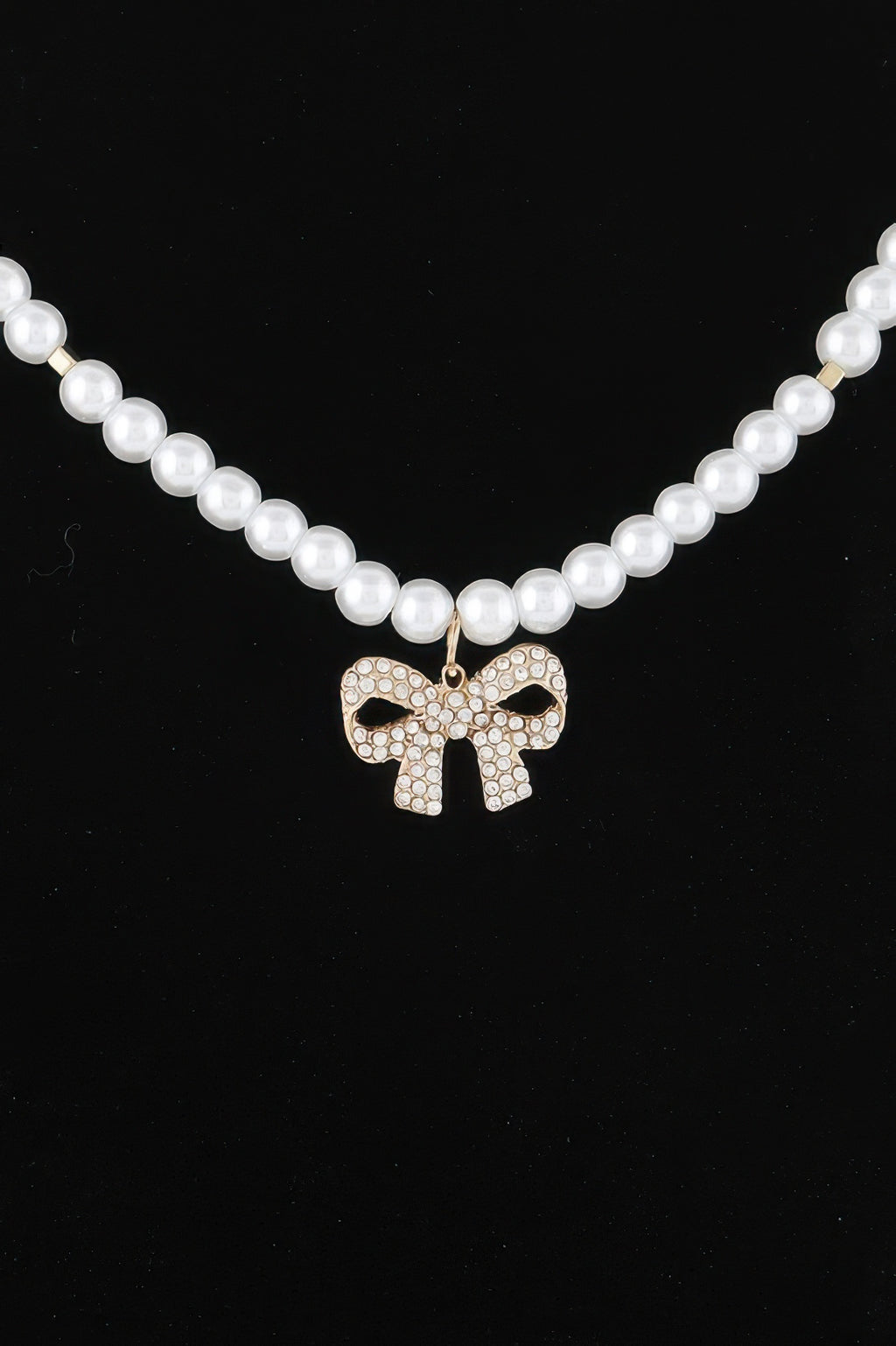 Double-row pearl bow necklace, gold-tone bow charm with clear stones
