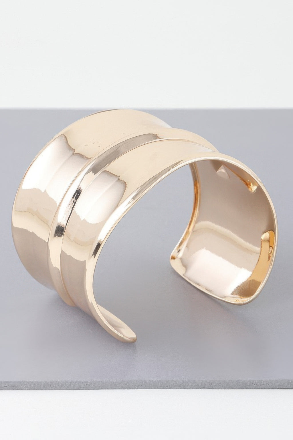 Gold wide open cuff bracelet with ribbed texture, side view