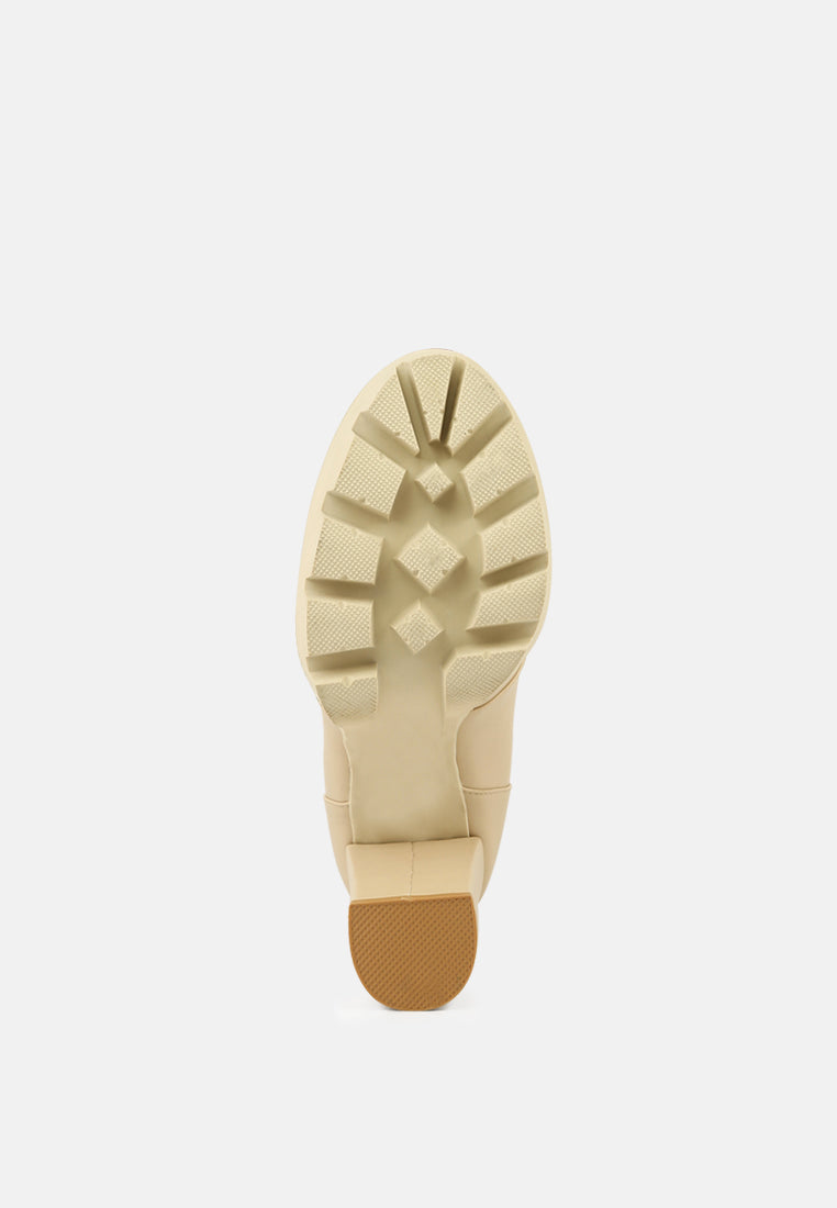 Beige combat boot outsole view with lug tread and platform heel base