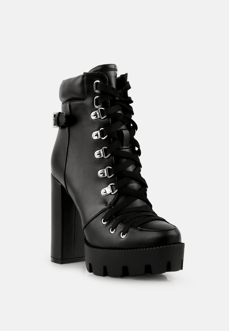 Black combat boot front view with lace-up eyelets and platform lug sole