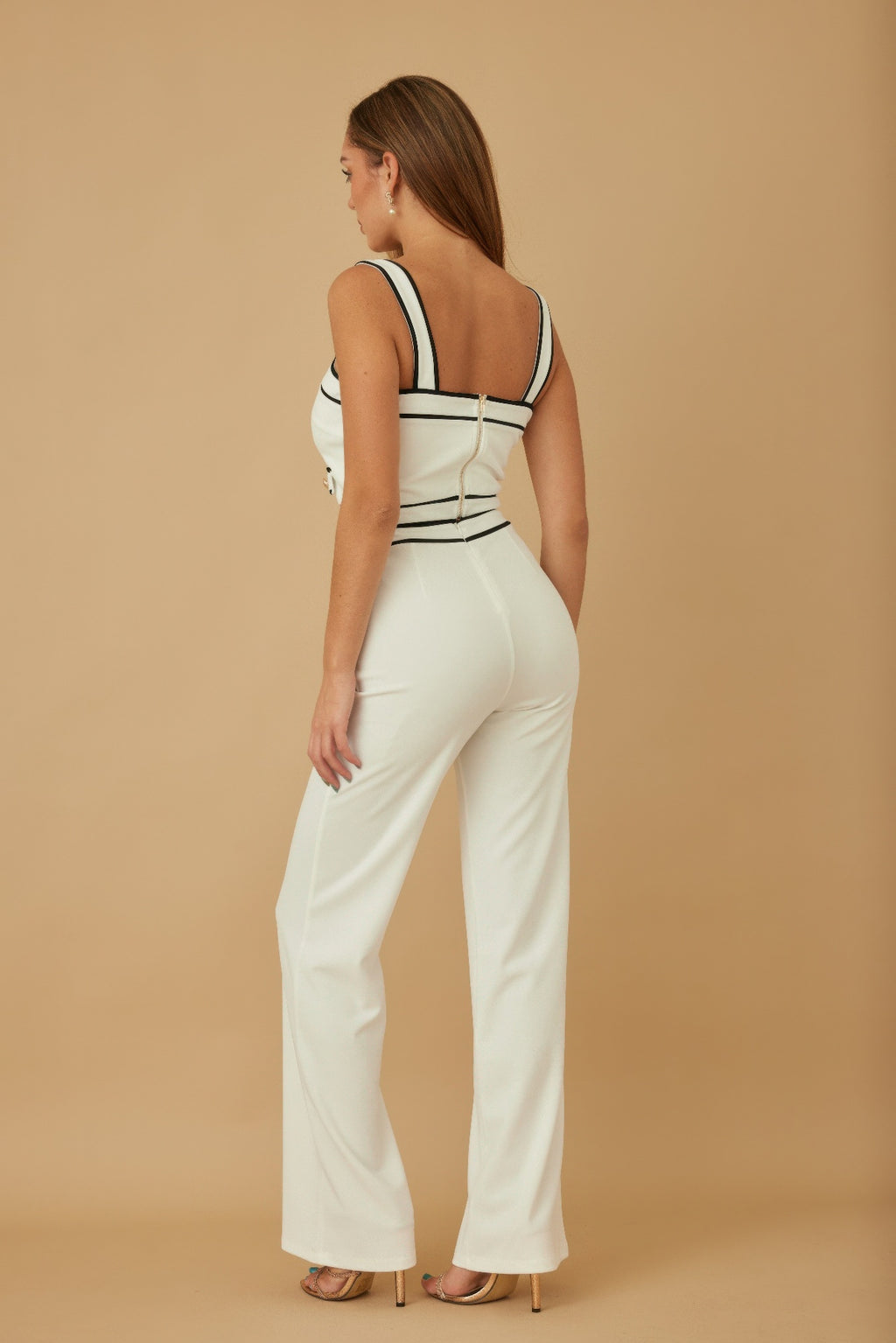 Back view of white contrast two-piece set: sleeveless crop top with black trim and wide pants