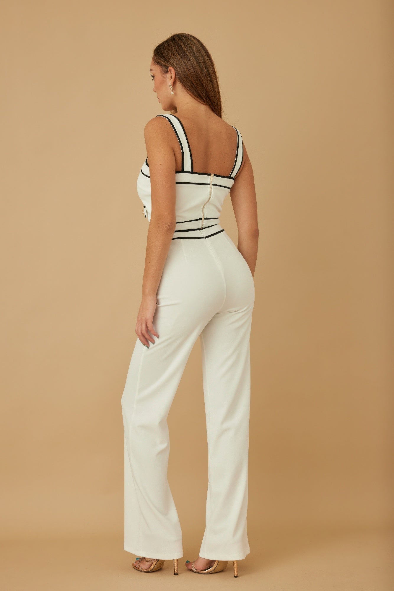 Back view of white contrast two-piece set: sleeveless crop top with black trim and wide pants