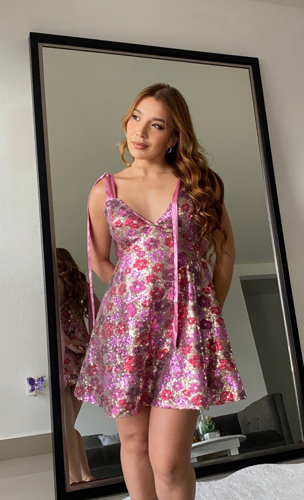 Pink glitter floral mini dress with spaghetti tie straps and V-neck