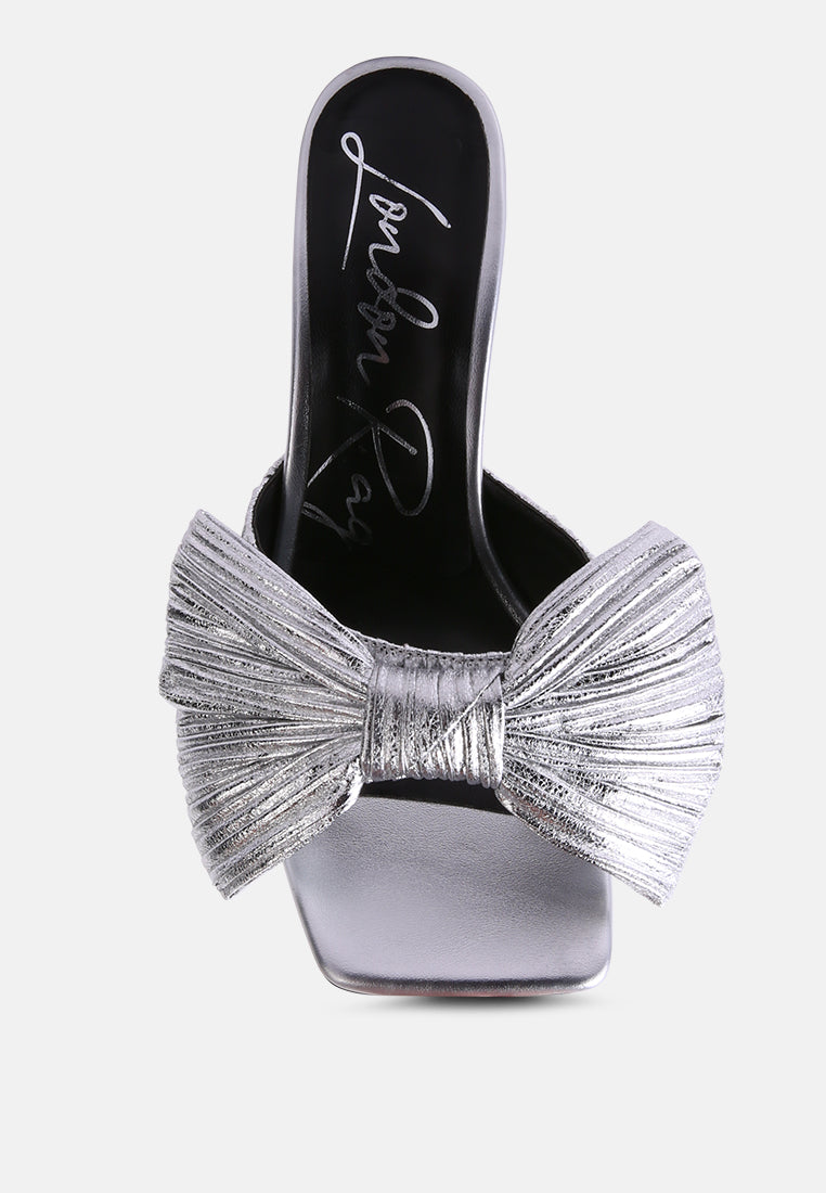 Silver mule-style bow slide sandals with open toe and knotted bow detail
