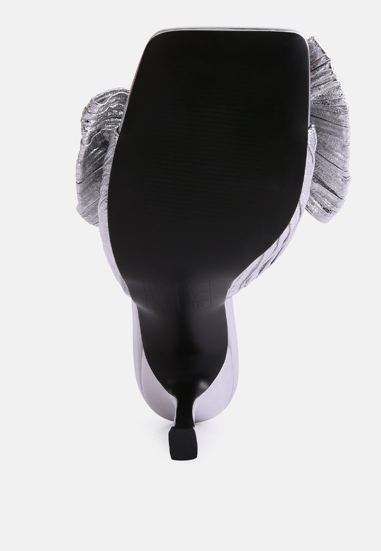 Silver bow slide sandals, heel-back view with stiletto heel and knotted strap