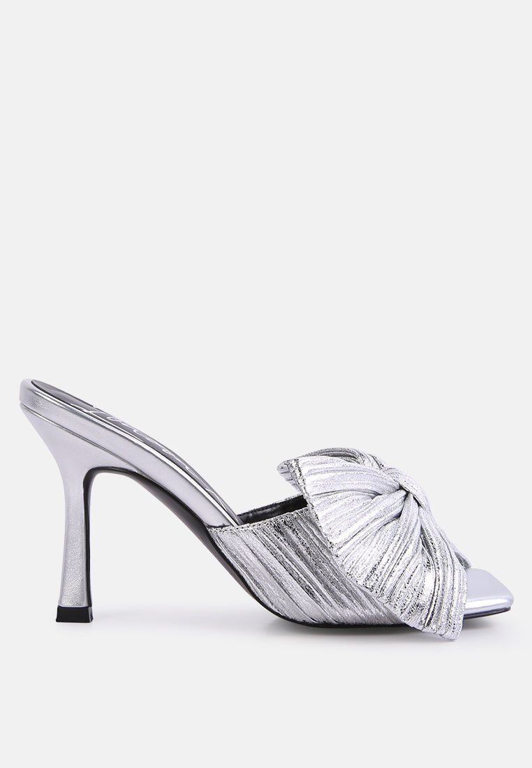 High-heeled bow slide sandals in silver with knotted strap across the front