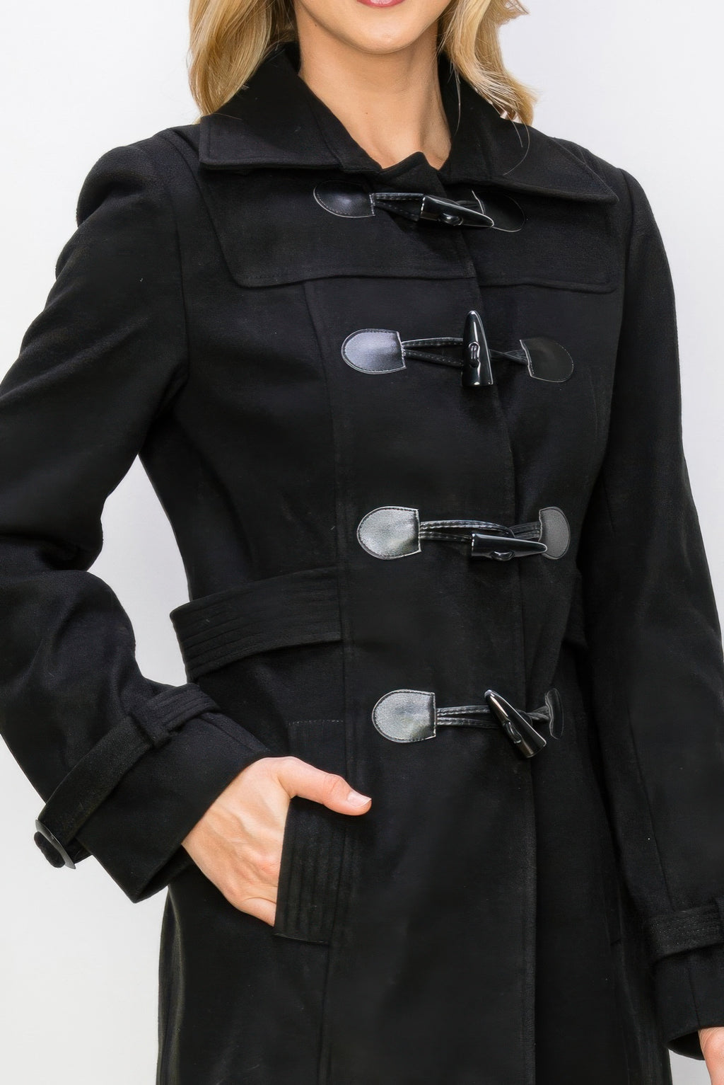 Close view: black wool peacoat with toggle fasteners and stitched pocket flaps