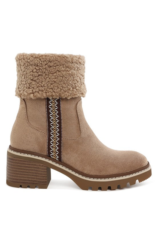 Beige ankle boot with embroidered vertical stripe, faux fur cuff, and lug sole