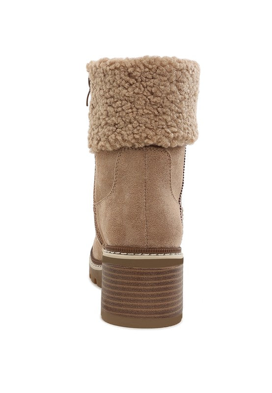 Beige back view ankle boot with faux fur cuff, pull-on tab, and treaded stacked heel