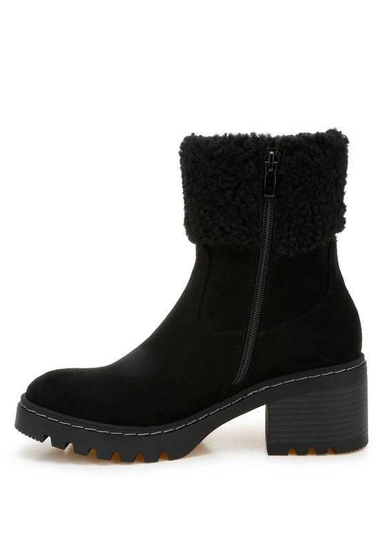 Black suede-look ankle boot with rear zipper, fuzzy cuff, and lugged platform heel