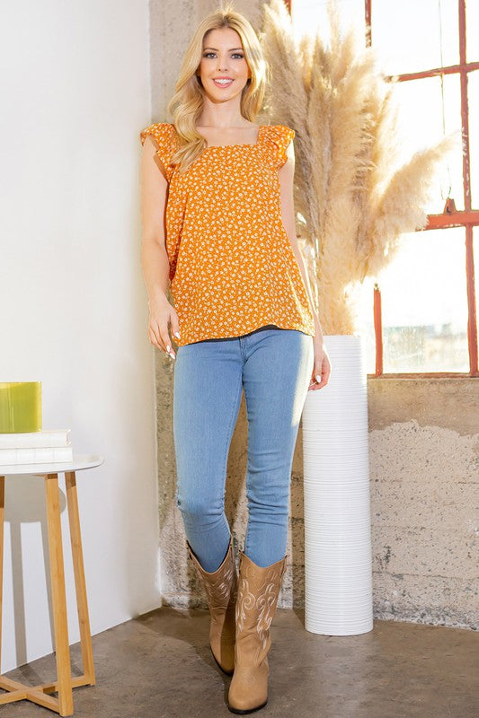 Orange floral woven top with ruffle cap sleeves and straight hem