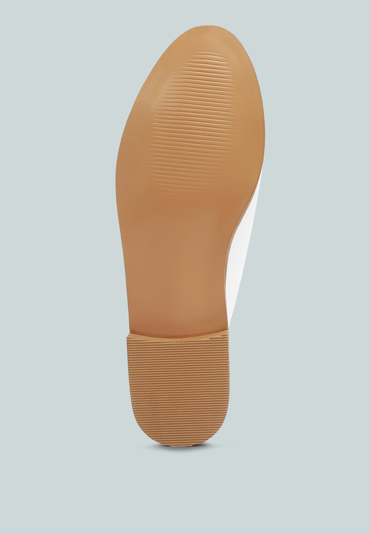 Yashta patent studded flat mules (white) outsole/sole bottom view with textured tread.