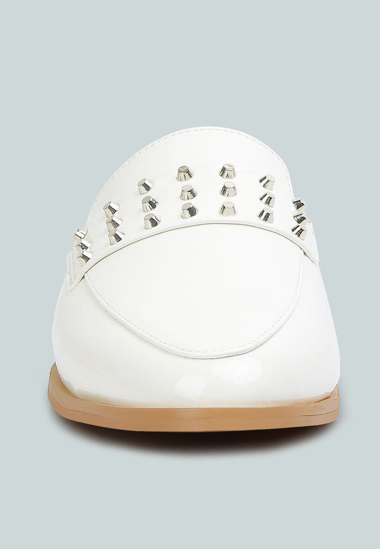 Yashta patent studded flat mules (white) heel side with studded strap detail.