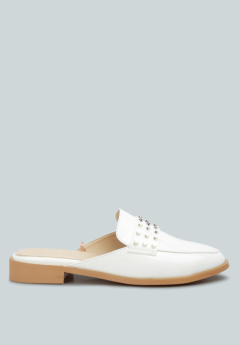Yashta patent studded flat mules (white) with side buckle detail and low heel.