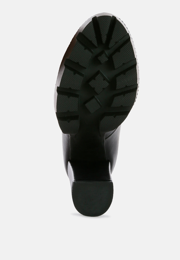 Outsole tread of Yeti black high-heel boots, rugged crosshatch grip pattern
