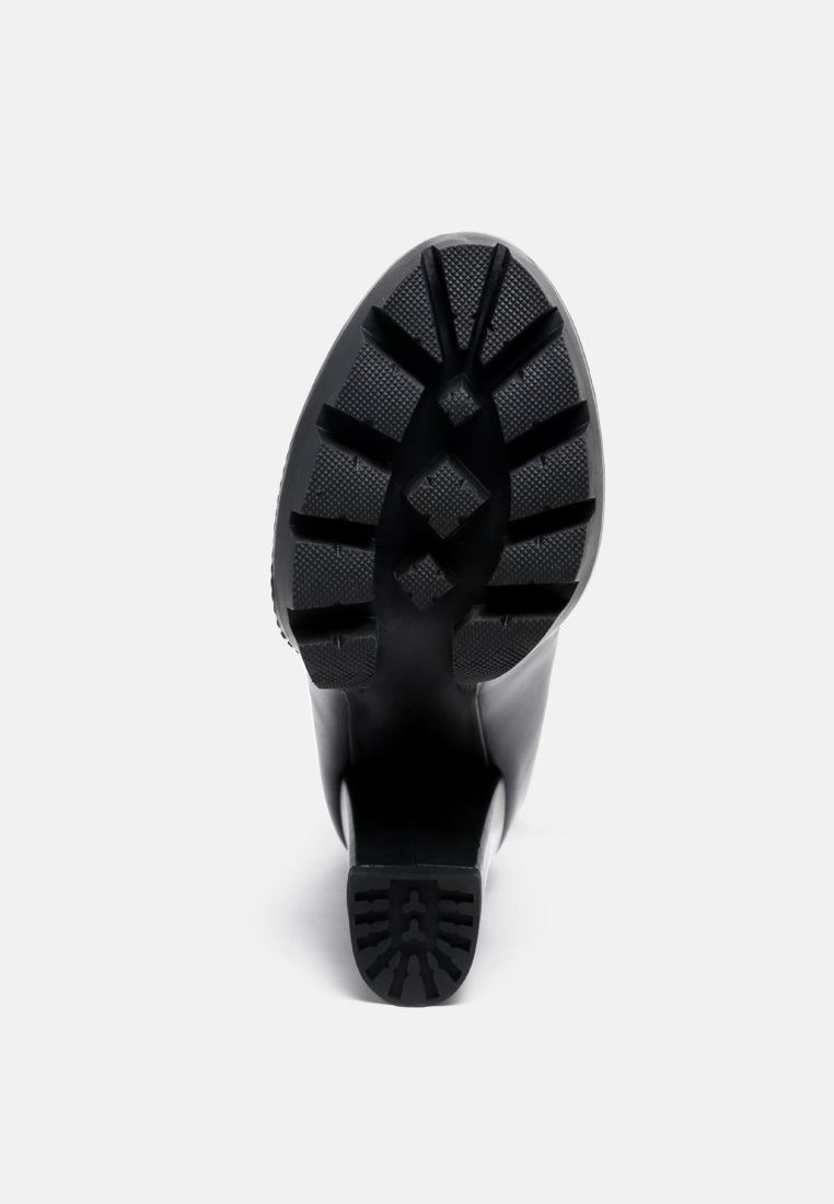 Yeti high heel lace-up biker boots, black outsole view with tread pattern