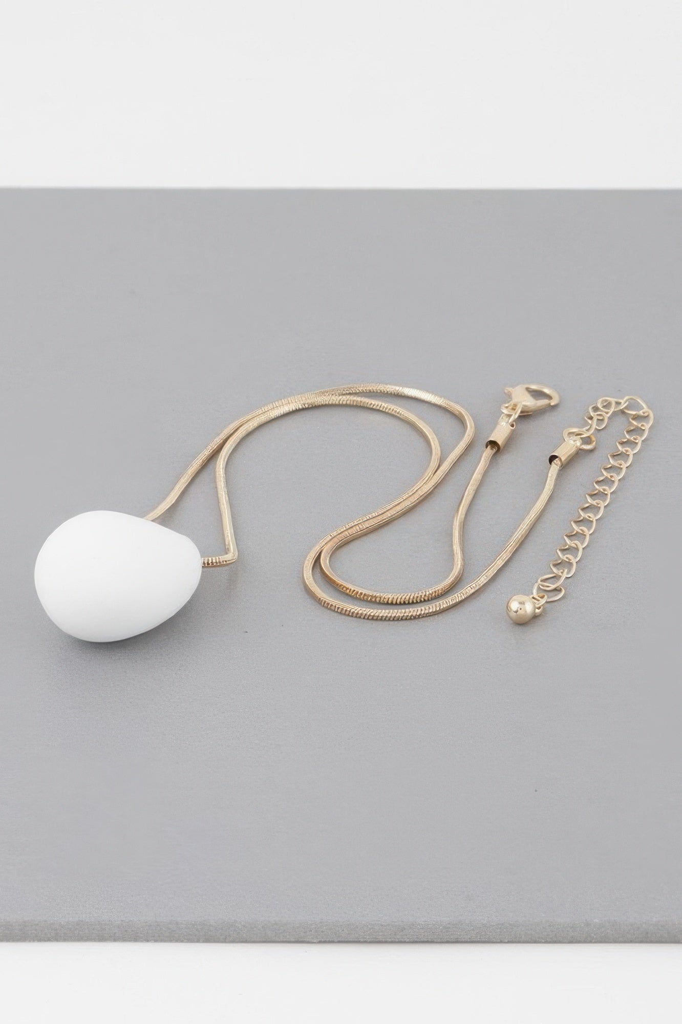 Yin Teardrop Necklace, white teardrop pendant with gold chain and extender chain