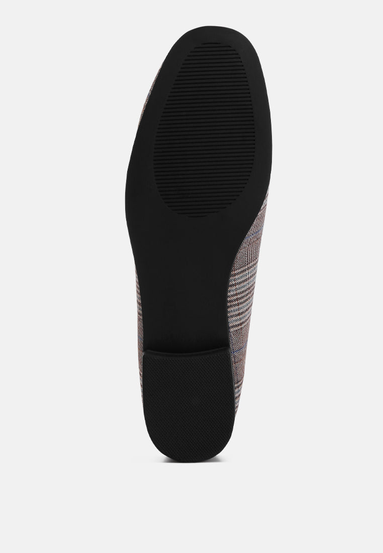 Grey plaid loafer outsole view with black rubber heel section