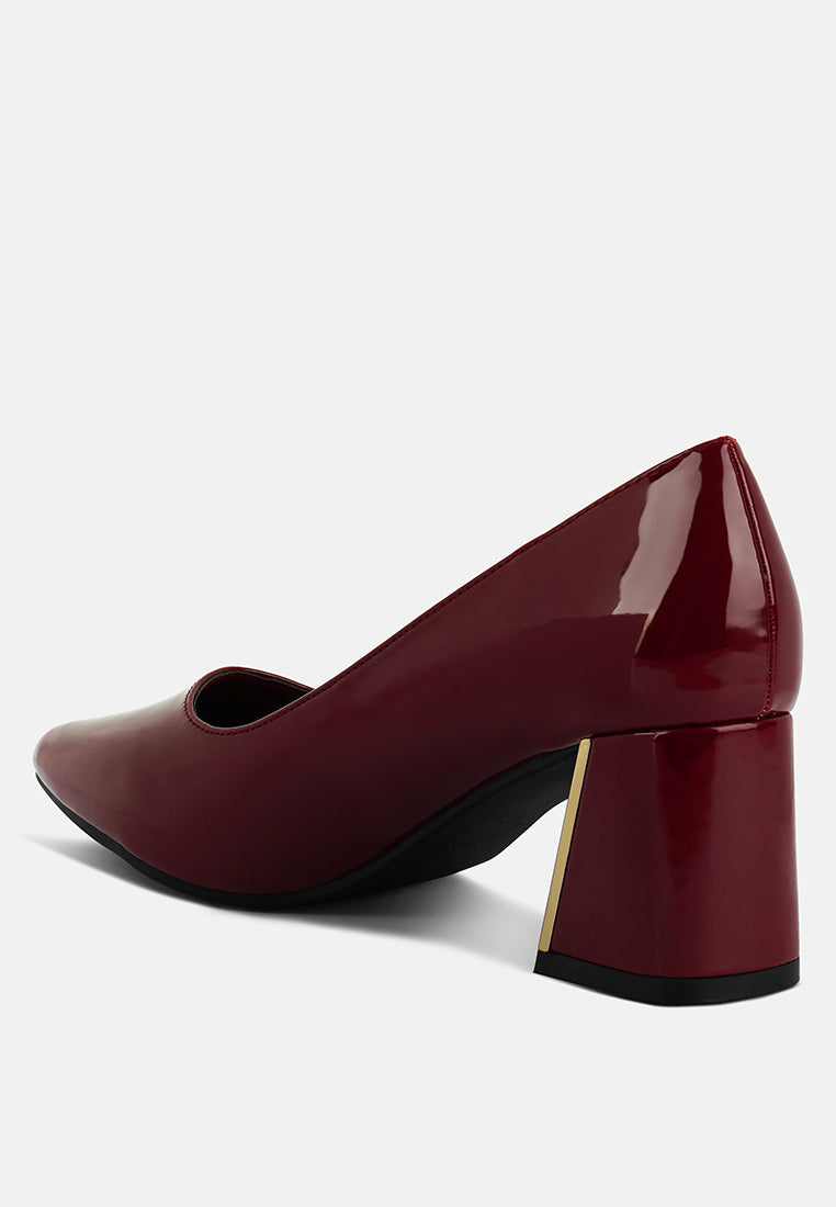 Burgundy pump profile with high block heel and curved pointed toe