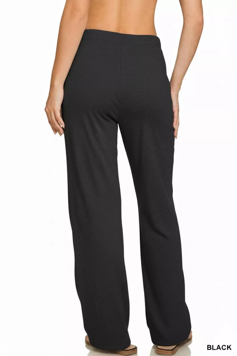 Black fleece sweatpants with straight wide-leg silhouette and smooth jersey-knit look