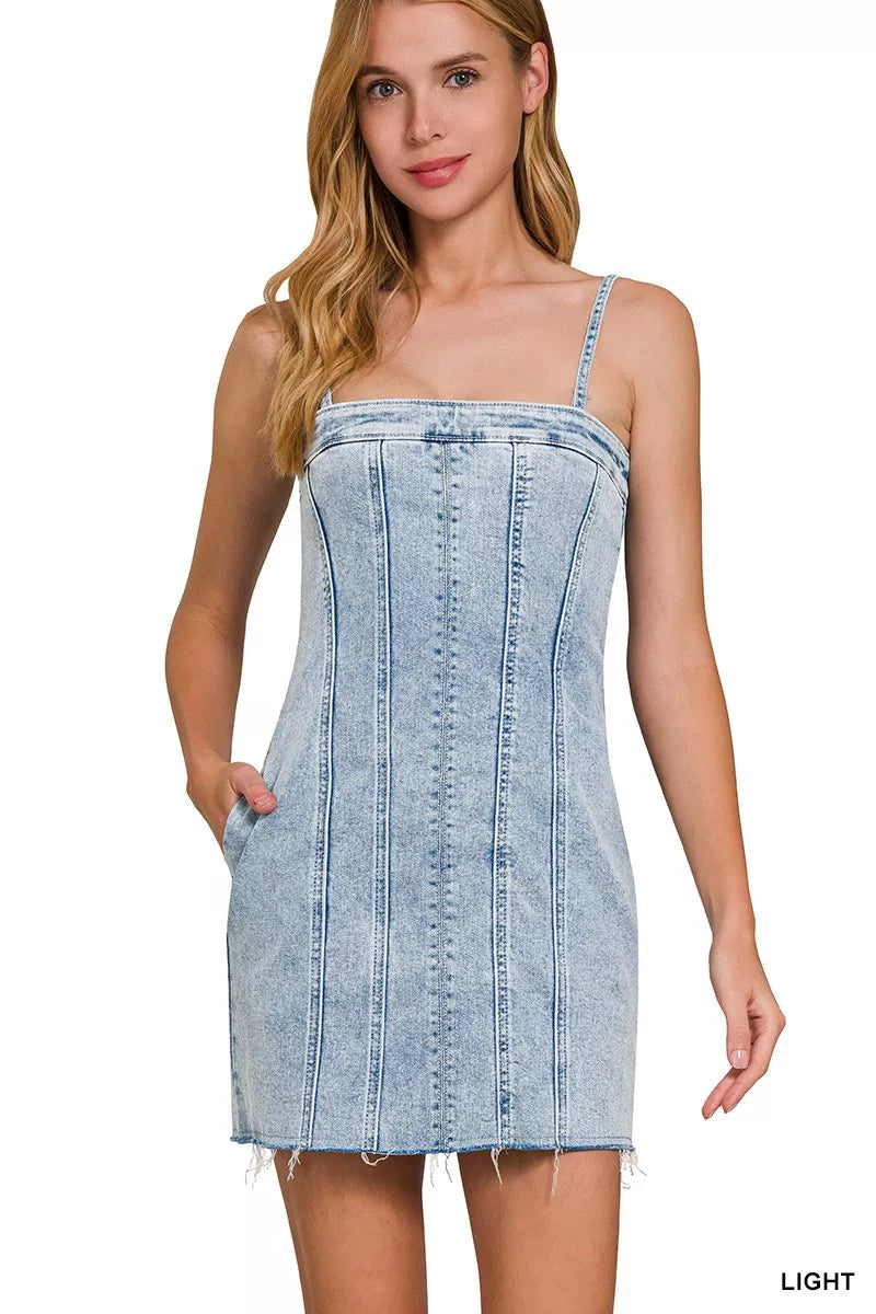 Light-wash denim mini dress with spaghetti straps and vertical exposed seam stitching
