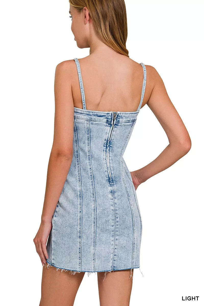 Back view of light-wash denim spaghetti strap mini dress with exposed seams