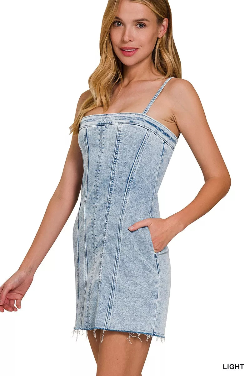 Light-wash denim spaghetti strap mini dress with curved bust seam and side pocket