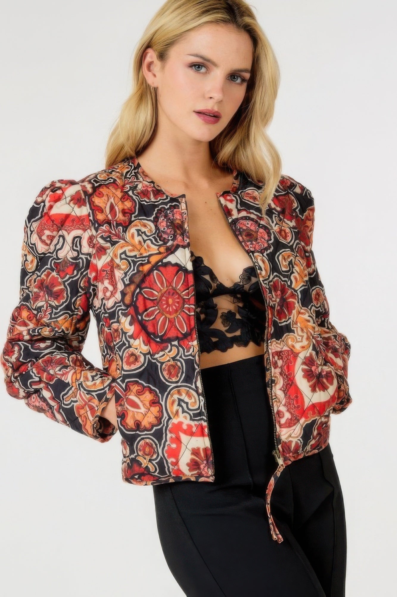 Zip-up multi-print jacket, black base with red and tan floral paisley, open collar with zipper.