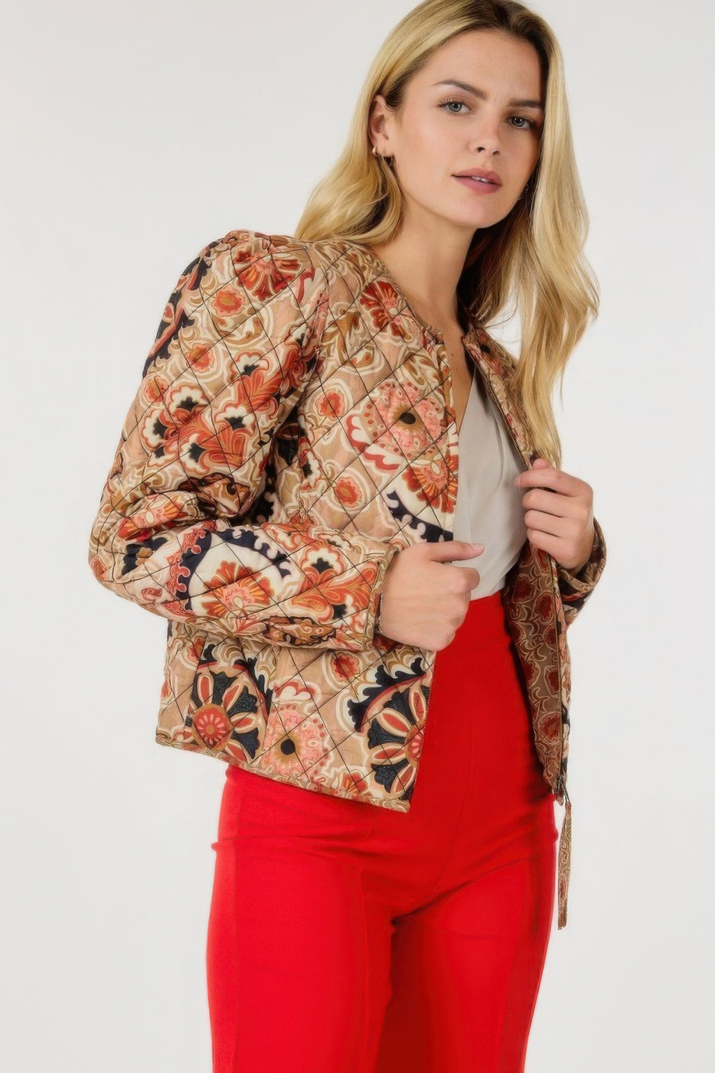 Tan zip-up multi-print jacket with orange-red floral and paisley pattern, front zipper closure.