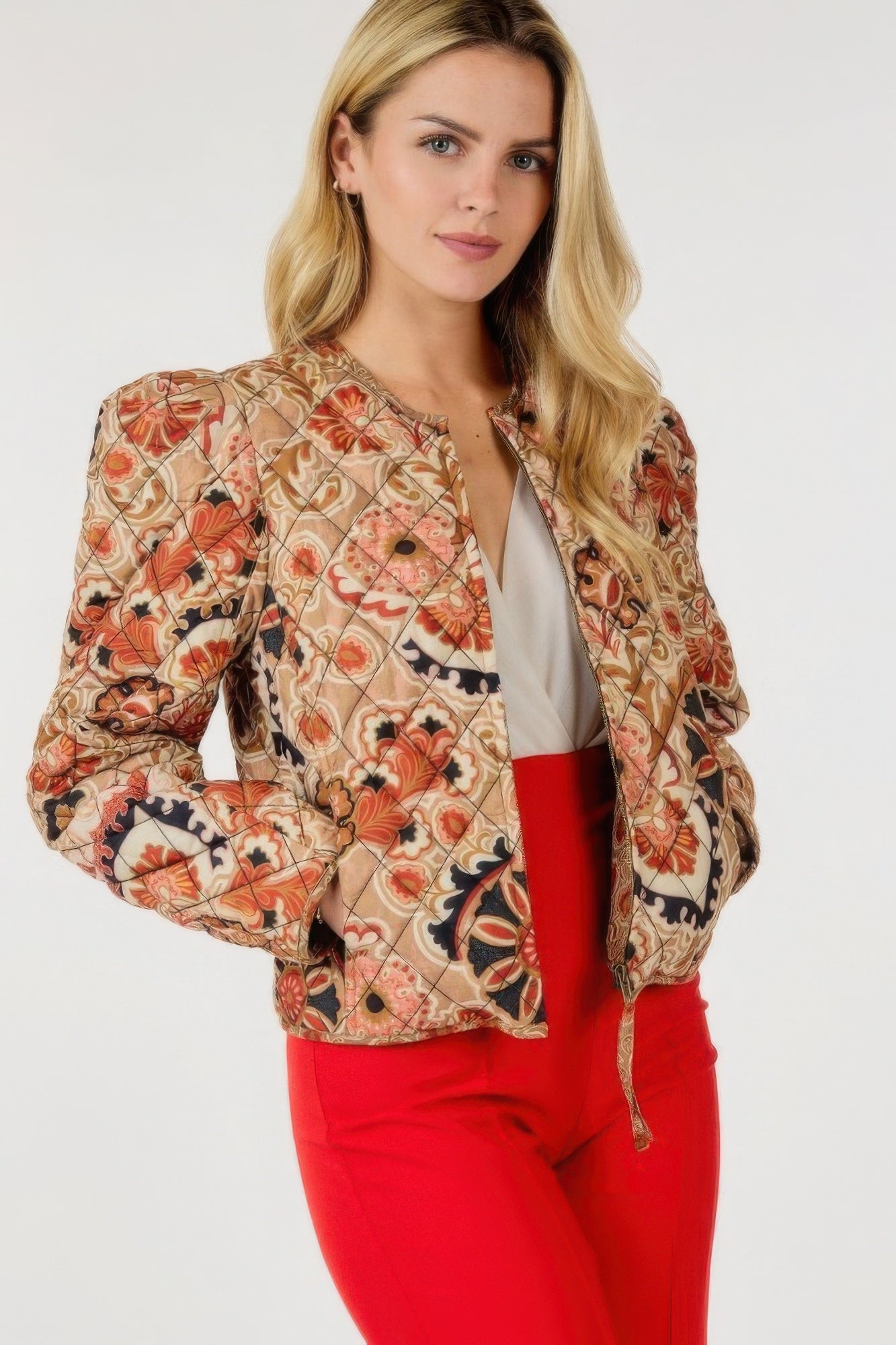 Tan zip-up multi-print jacket with orange, red, and navy floral/paisley design, front zipper.