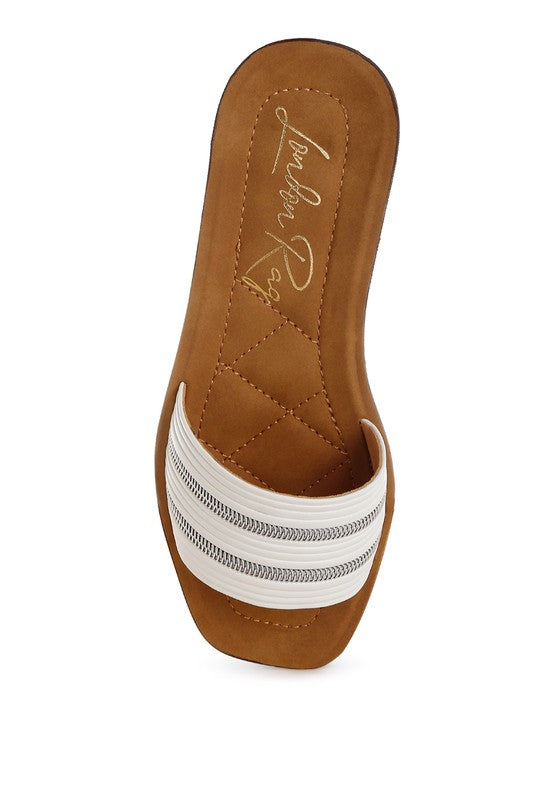 Tan slip-on mule with faux zipper trim and stitched diamond pattern