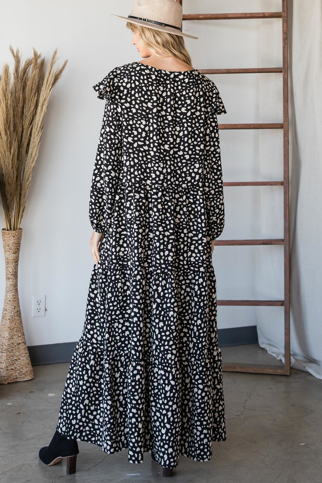 Bohemian maxi dress back view in black with white irregular heart print and tiered skirt